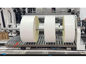 Finished roll discharge and transfer device