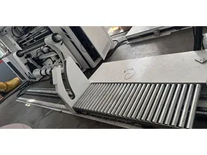 Finished roll discharge and transfer device